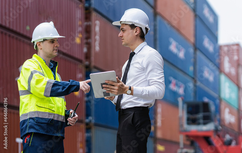 Dock workers inspecting container shipping in the distribution warehouse