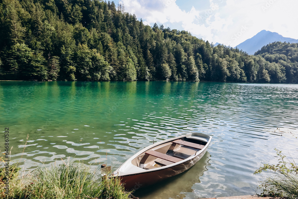 Lonely boat on the shore of Alat See lake in Bavaria, Germany