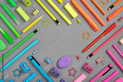 Photos Round frame of colorful rainbow school and office stationery set on gray background