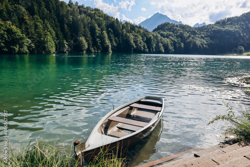 Lonely boat on the shore of Alat See lake in Bavaria, Germany