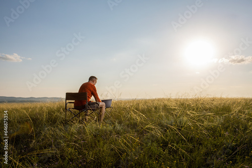 man freelancer traveler working online using laptop and enjoying nature view. remote work concept.