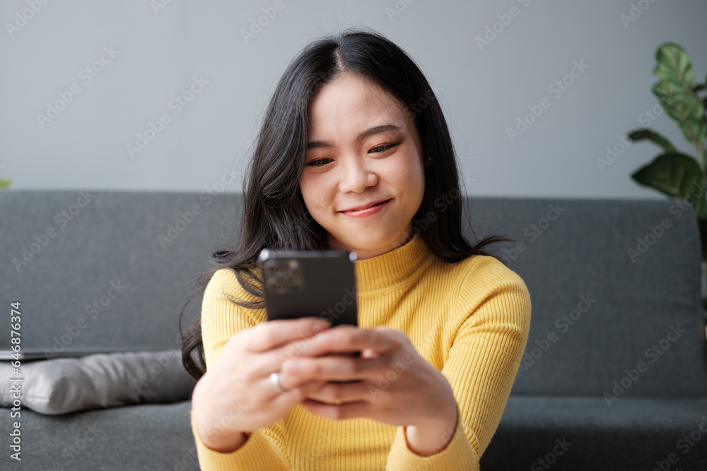 Attractive Asian woman resting comfortable living room and using mobile phone, Relax, Sofa, Lifestyle Attractive Asian woman resting comfortable living room and using mobile phone, Relax, Sofa, Lifestyle