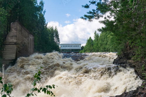 waterfall during opened locks for idle discharge of water at a small hydroelectric power station photo