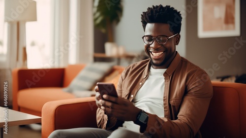 Young Cameroonian Male using smartphone at Home photo