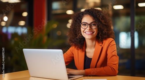 Happy Young Lady Working at the Office on a Laptop