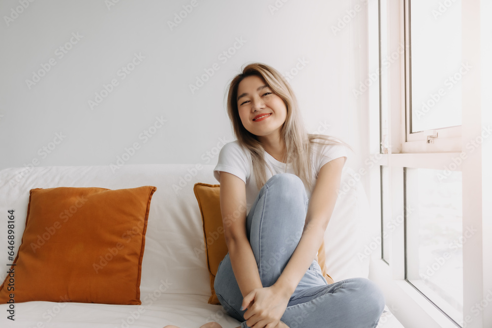 Happy asian women sitting on sofa look at camera at apartment. Happy asian women sitting on sofa look at camera at apartment.