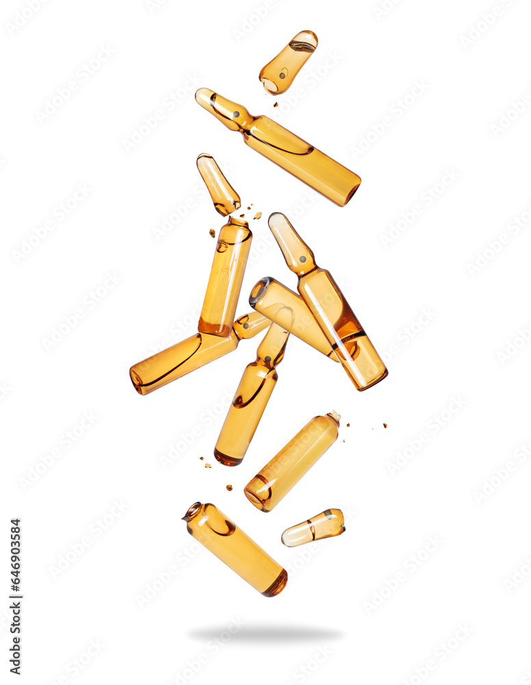 Group of broken yellow ampoules in the air isolated on a white background Group of broken yellow ampoules in the air isolated on a white background