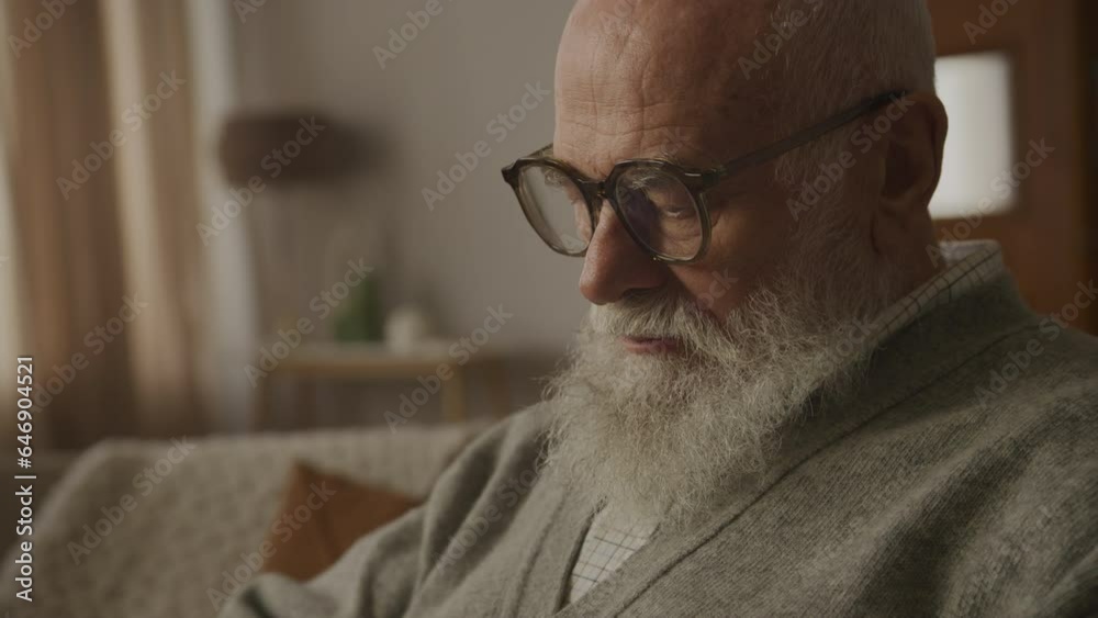 Thoughtful Grandfather in Eyeglasses Working on Laptop Thoughtful Grandfather in Eyeglasses Working on Laptop