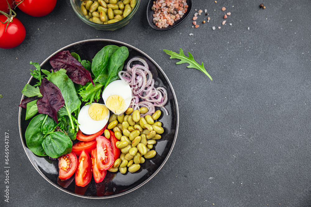 fresh salad edamame bean vegetable tomato, boiled egg meal food snack on the table copy space food background rustic top view  diet vegetarian vegan  