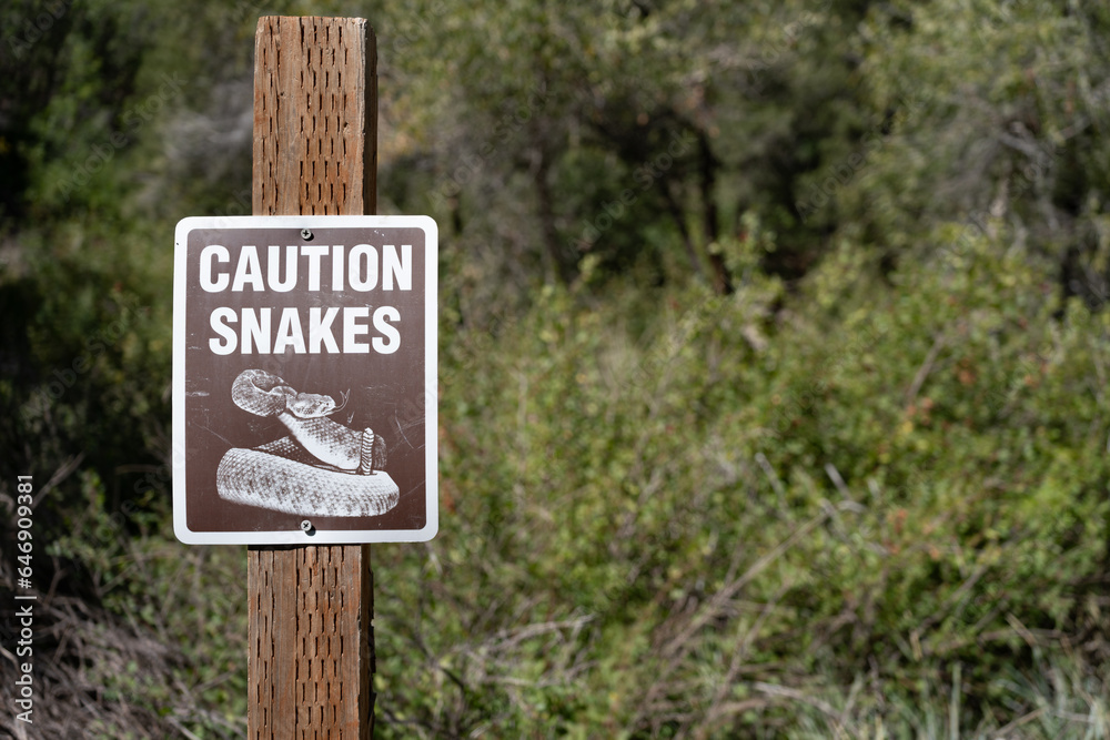 Snake caution sign at remote camping location Snake caution sign at remote camping location