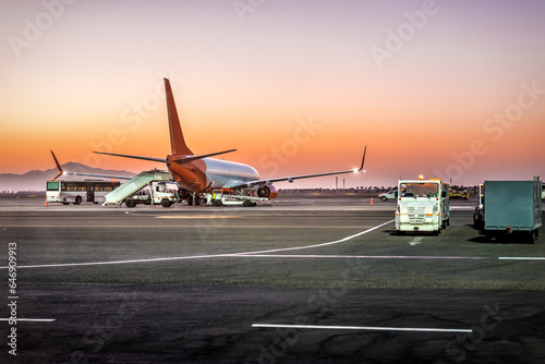 Airplane during maintenance against sunrise or sunset