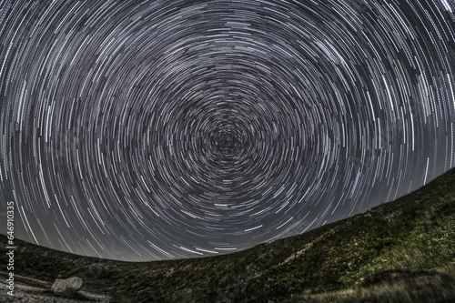 Trails of stars above the peaks: An enchanting Star Trail in the mountains