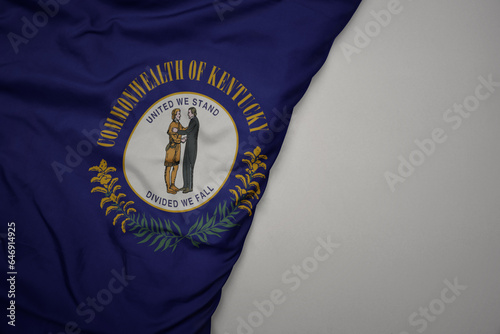 big waving national colorful flag of kentucky state on the gray background.