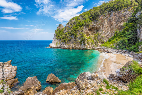 Fototapeta Naklejka Na Ścianę i Meble -  Scenic view of Fakistra beach in Pelion in Greece with the emerald water of the Aegean sea and a summer day dramatic sky