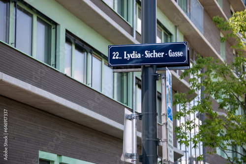 Photography A sign on a pole with the name of the Lydia-Sicher-Gasse street in Vienna