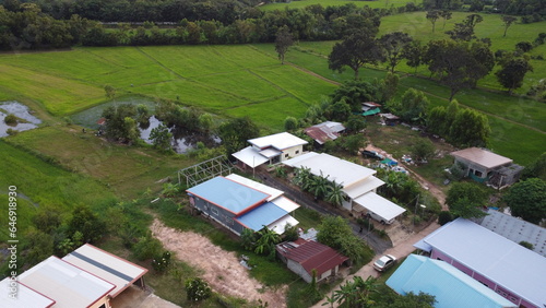 Aerial view of green fields and farmlands in rural Thailand.