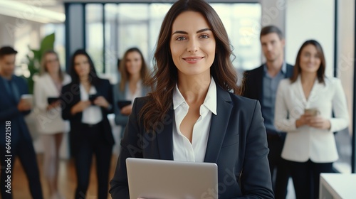 portrait of beautiful business woman standing with crossed arms in office background