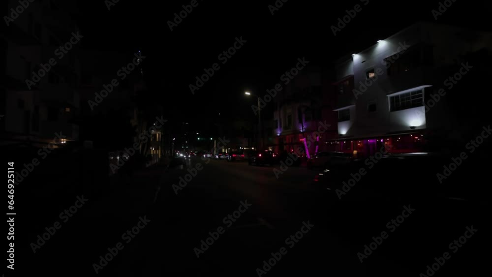 Beautiful night view of Collins Avenue with passing cars. Miami Beach. USA. Beautiful night view of Collins Avenue with passing cars. Miami Beach. USA.