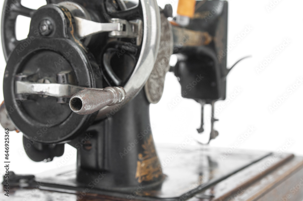 Fototapeta premium Antique sewing machine close up on a white background