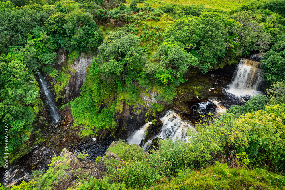 Green landscape with waterfalls coming down from the mountains on the Isle of Skye, Scotland, UK. Green landscape with waterfalls coming down from the mountains on the Isle of Skye, Scotland, UK.