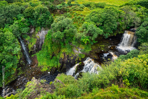 Green landscape with waterfalls coming down from the mountains on the Isle of Skye  Scotland  UK.