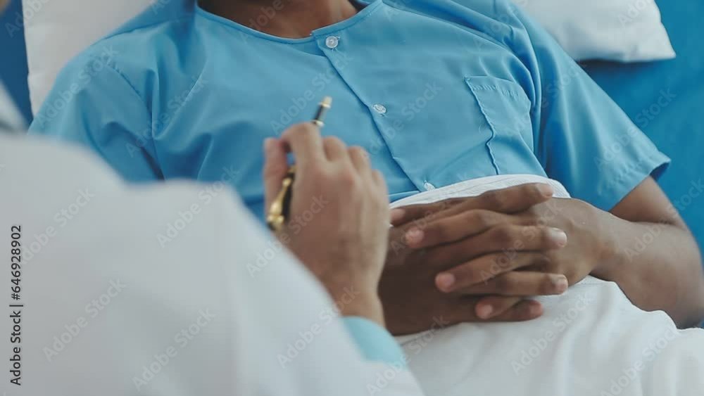 Senior doctor and young male patient who lie on the bed while checking pulse, consult and explain with nurse taking note and supporting in hospital wards. Senior doctor and young male patient who lie on the bed while checking pulse, consult and explain with nurse taking note and supporting in hospital wards.