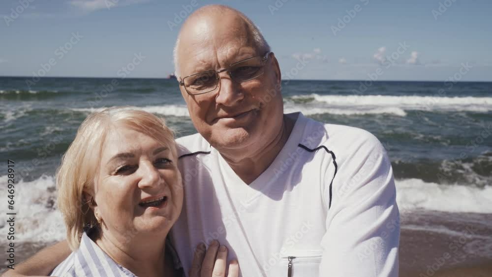 A couple of cute elderly people enjoy their vacation at the sea - take a selfie, look at the camera. A couple of cute elderly people enjoy their vacation at the sea - take a selfie, look at the camera.