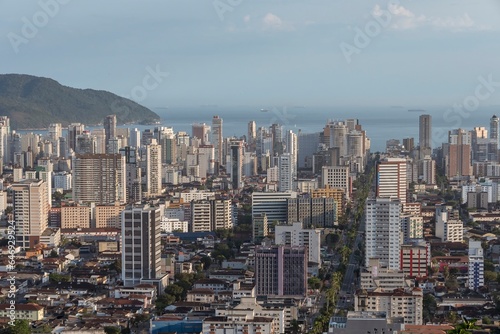 City of Santos, Brazil. Aerial view of the city. Ana Costa avenue on the left crossing the neighborhoods of Vila Mathias, Campo Grande and Gonzaga. In the background the sea and ships on the horizon.