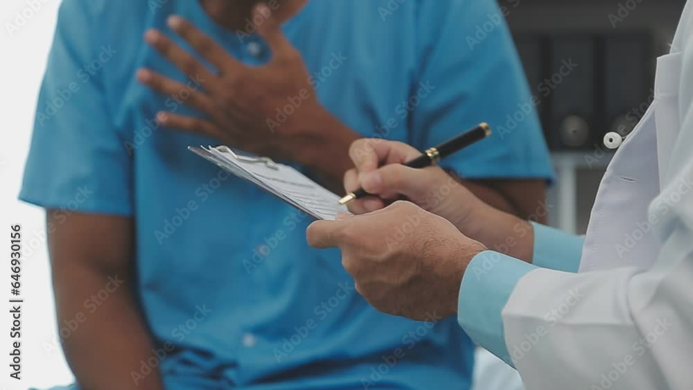 Senior doctor and young male patient who lie on the bed while checking pulse, consult and explain with nurse taking note and supporting in hospital wards. Senior doctor and young male patient who lie on the bed while checking pulse, consult and explain with nurse taking note and supporting in hospital wards.