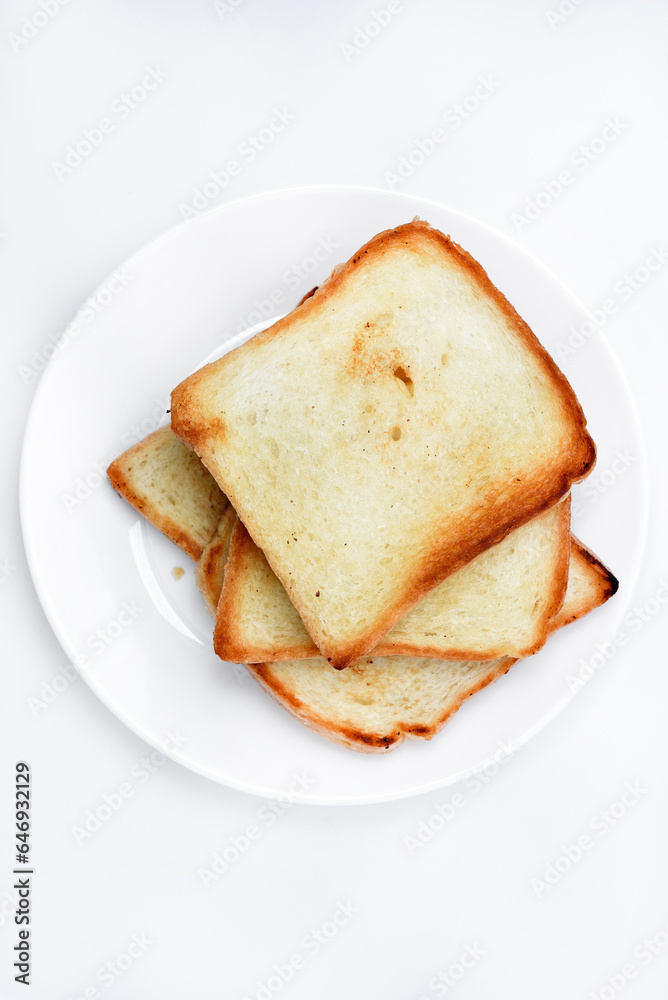 Fried toast on a white plate. Baked bread for sandwiches. Vegan food.