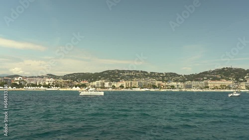 Wallpaper Mural A pleasure boat sails from the Lérins Islands towards Cannes, France. View of Cannes from the Mediterranean Sea. Torontodigital.ca