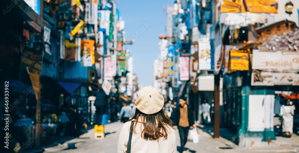 Asian girl standing out from the crowd at a city street in Japan.