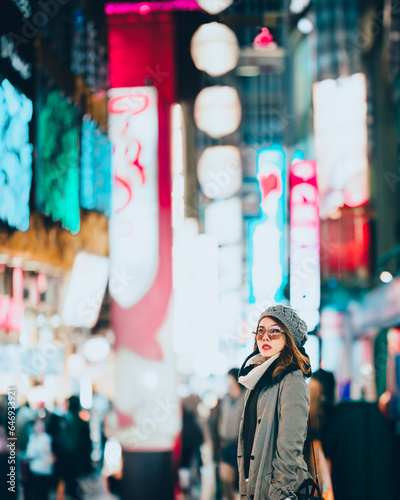 Asian girl standing out from the crowd at a city street in Japan.