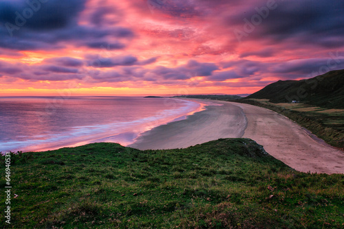 Sunset over the beach at Rhossilli, Wales, UK.