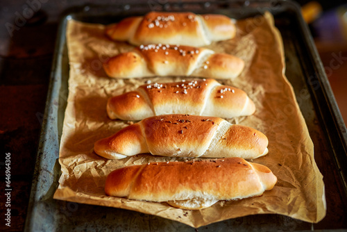 Crispy, homemade, baked, traditional czech white bread roll (rohlík) on baking tray