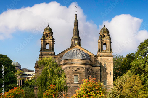 Edinburgh, Scotland, St Cuthbert's Parish Church amongst the trees of Princes Street Gardens in late summer or early autumn. Designed by Hyppolite Blanc and completed in 1894. photo