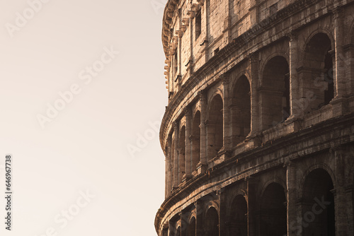 Close-up architectural detail of the iconic Flavian Amphitheatre, the ancient Roman Colosseum, a famous tourist landmark in historic city of Rome, Italy Fototapet
