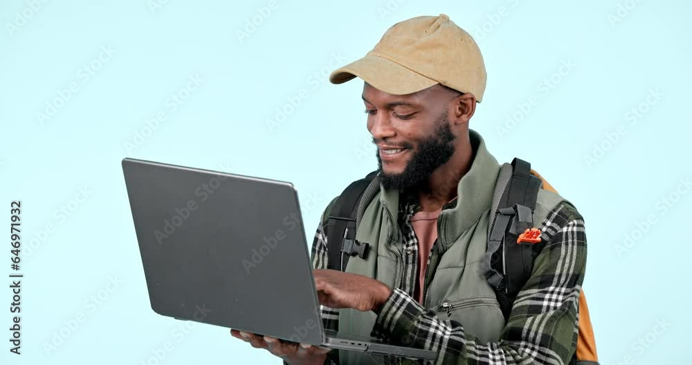 Laptop, hiking and a black man online shopping on a blue background in studio for a camping hobby. Computer, internet or research with a happy young hiker looking for directions to a location Laptop, hiking and a black man online shopping on a blue background in studio for a camping hobby. Computer, internet or research with a happy young hiker looking for directions to a location