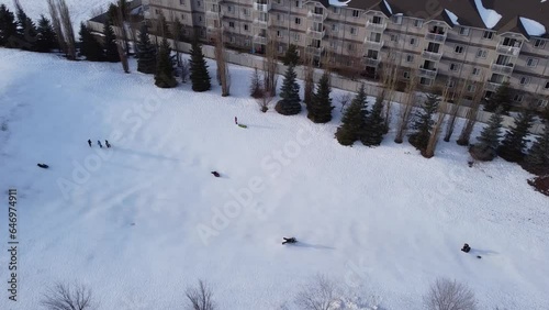 Video from above a toboggan hill with people sliding down hills photo