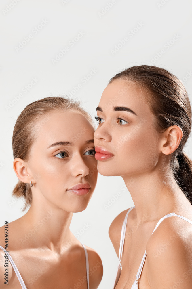 Portrait of attractive young women on light background Portrait of attractive young women on light background