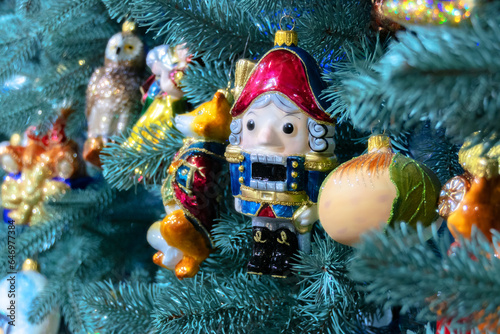 New Year's decoration Nutcracker hanging on the Christmas tree. photo