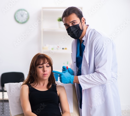 Fototapeta Naklejka Na Ścianę i Meble -  Young woman visiting male doctor dermatologist
