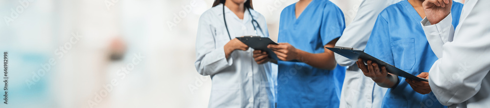 Medical staff team with doctor nurse and specialist working together with laptop and tablet on blur hospital corridor background. Medical and healthcare community in panoramic banner. Neoteric - obrazy, fototapety, plakaty 