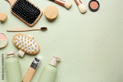 Composition with different bath supplies and cosmetic products on green background