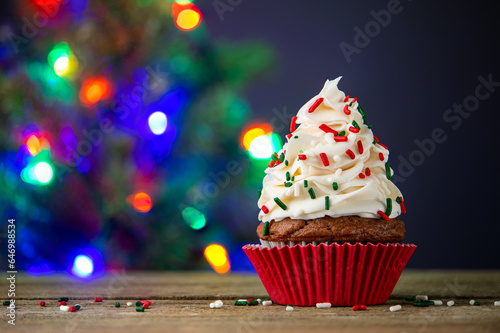 Cupcake. Cupcakes and Christmas Tree. Merry Christmas. Red cup liners. Tasty baking cupcakes  cake or muffin with white cream icing  frosting and colored sprinkles. Homemade bakery  confectionery shop