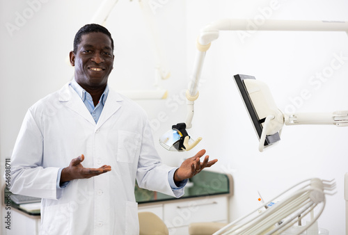 Positive african american dentist doctor in his clinic