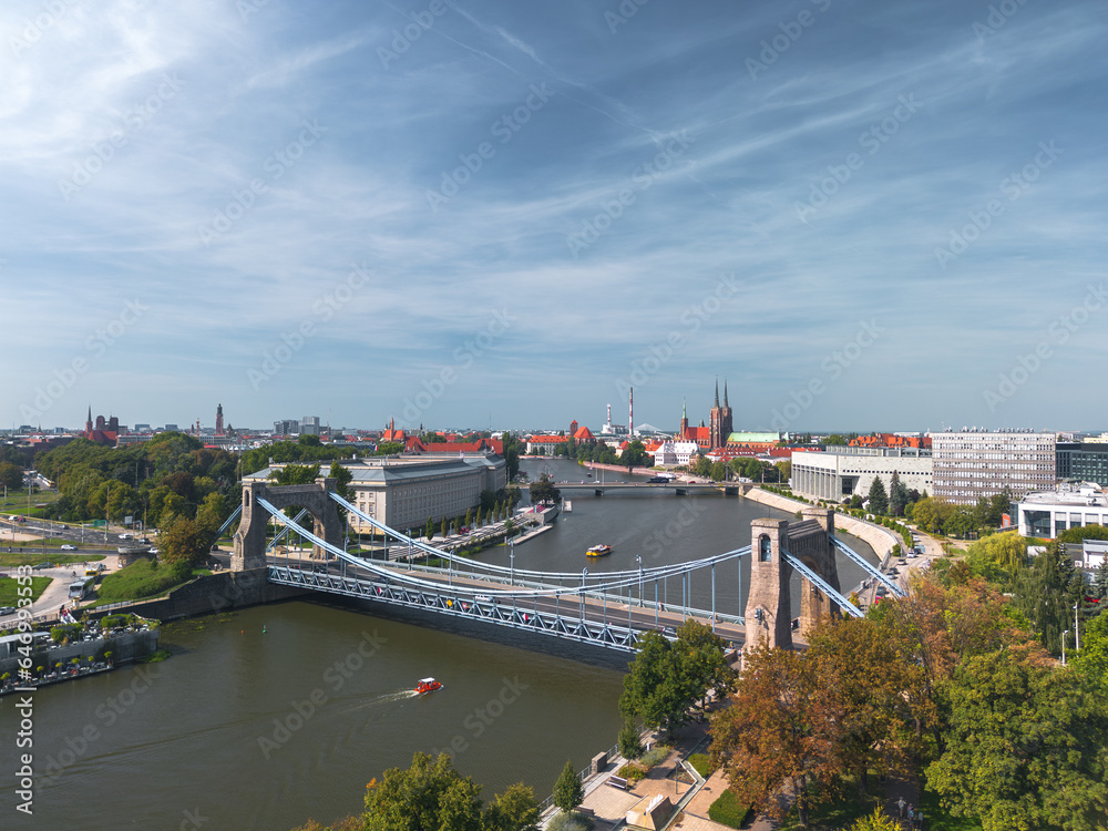 Summer panoramic cityscape of Wrocław, Poland, with a Grunwald Bridge (Most Grunwaldzki) in the foreground