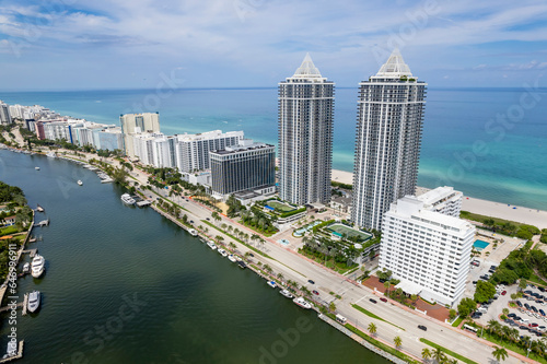 Miami Beach, Florida, USA - Aerial view of luxury apartments and hotels and the boardwalk stretching from Mid - Beach going north, between Indian Creek and the Atlantic Ocean.