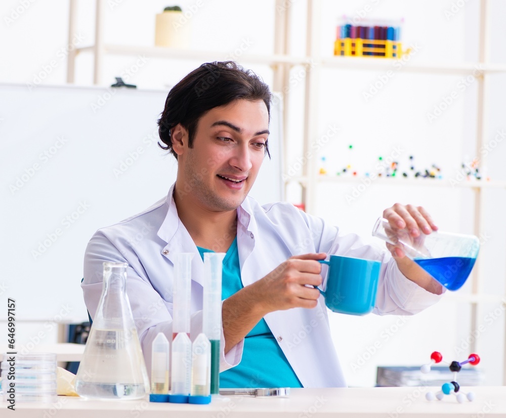 Young male chemist working in the lab Young male chemist working in the lab