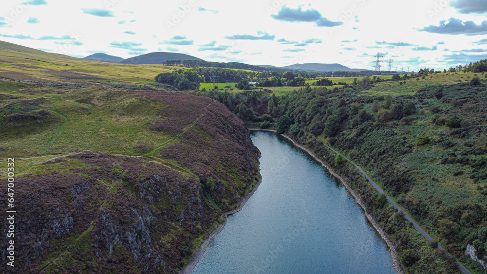 Nature in Scotland: Torduff Reservoir aerial view. A small elongated reservoir retained by an earth embankment dam in the City of Edinburgh. Nature in Scotland: Torduff Reservoir aerial view. A small elongated reservoir retained by an earth embankment dam in the City of Edinburgh.